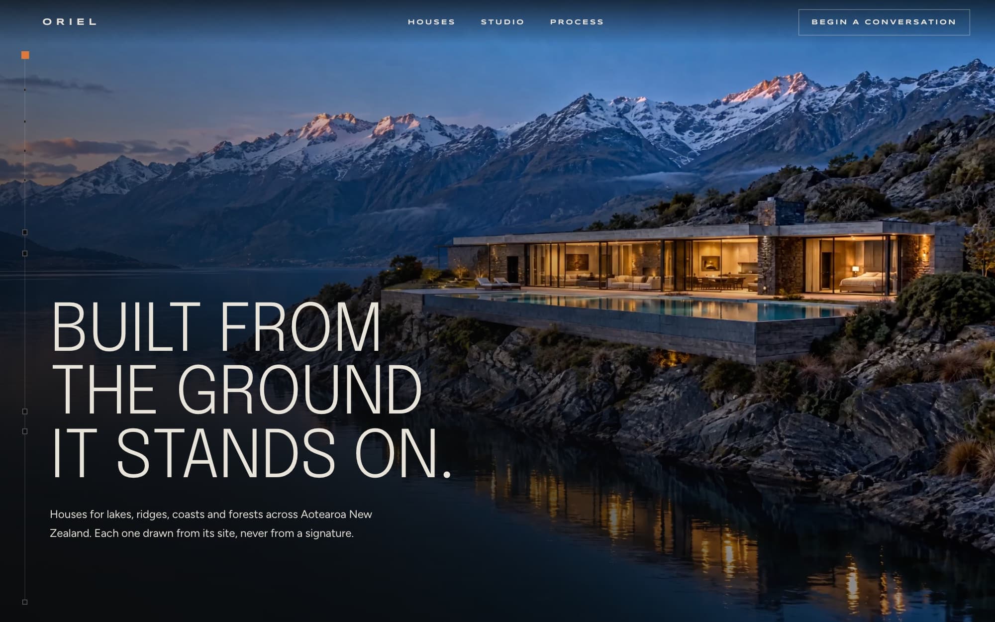 Oriel home page: 'Built from the ground it stands on' over the lakeside house at dusk.