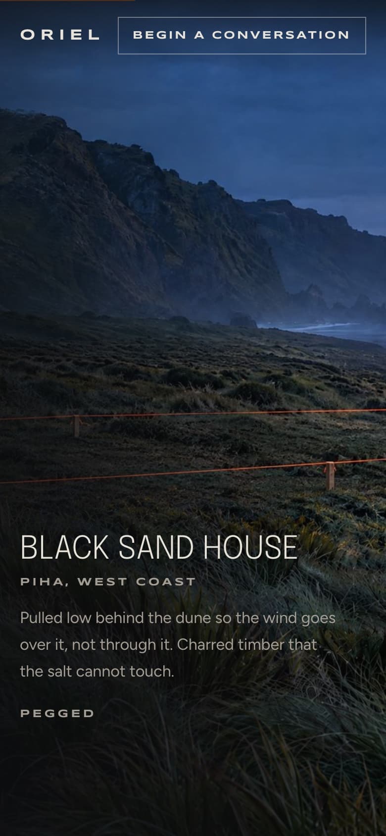 Oriel on a phone: Black Sand House, Piha.